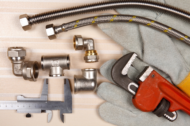 Plumber working on pipes in a Golders Green home