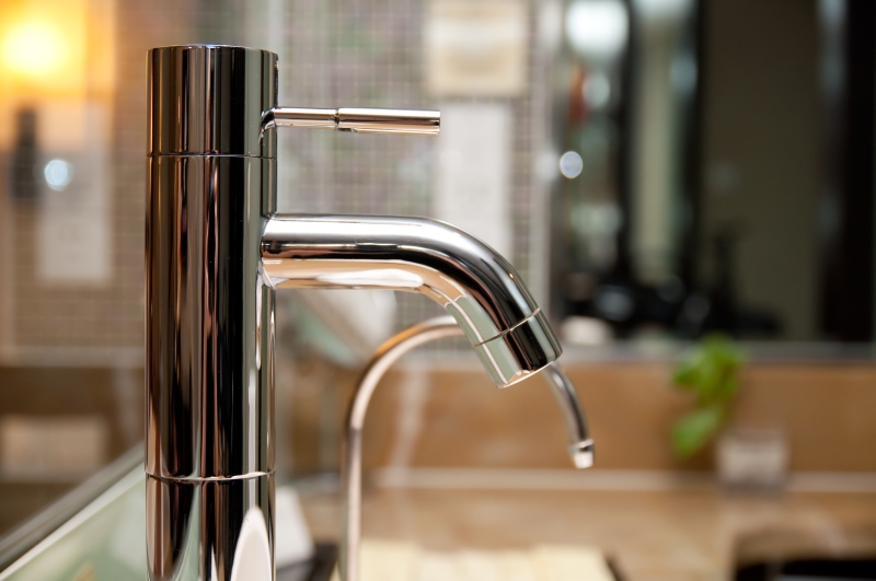 Leaking tap being repaired in Golders Green